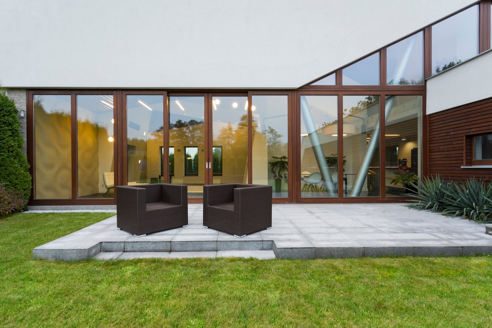 Villa patio with rattan chairs Villa with pool